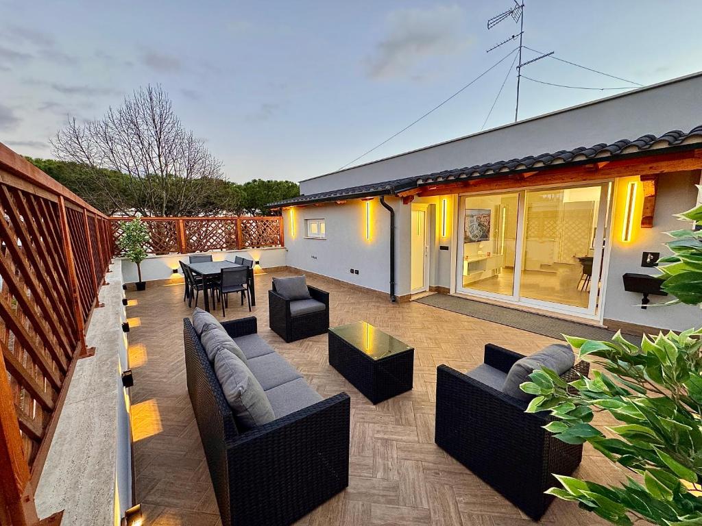a patio with couches and a table on a house at Luxury Apartment Togliatti in Rome