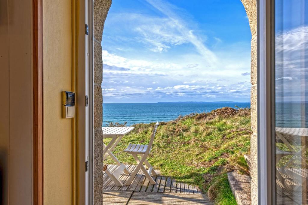 a view of the ocean from a door at Studio vue sur mer in Plomodiern