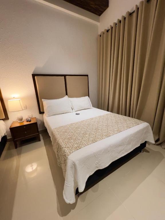 Postel nebo postele na pokoji v ubytování Hotel Dorado Plaza Centro Histórico