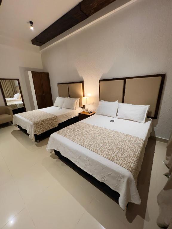 Postel nebo postele na pokoji v ubytování Hotel Dorado Plaza Centro Histórico