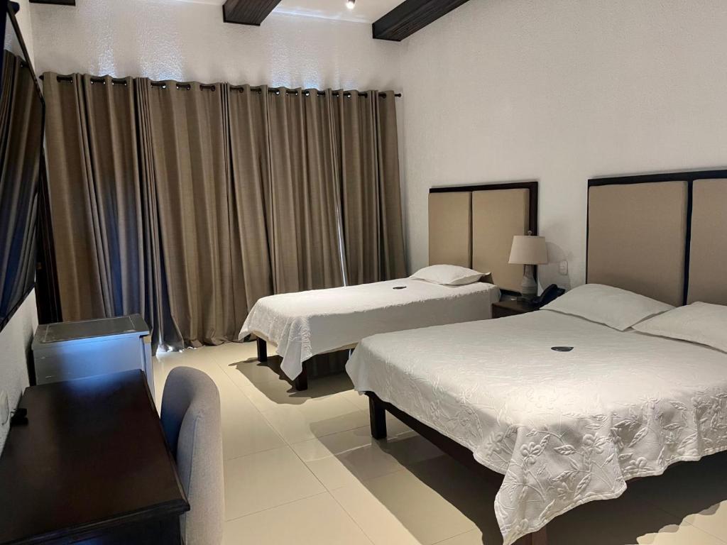 Postel nebo postele na pokoji v ubytování Hotel Dorado Plaza Centro Histórico
