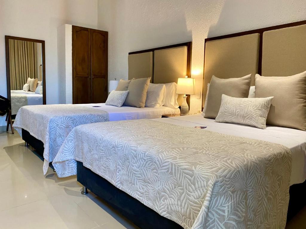 Postel nebo postele na pokoji v ubytování Hotel Dorado Plaza Centro Histórico
