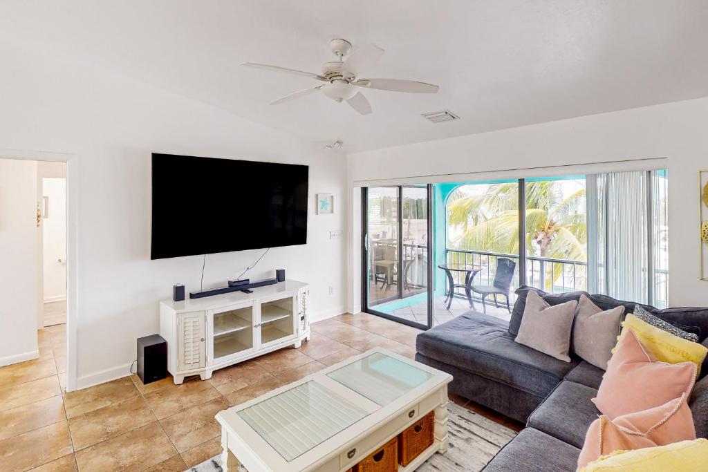 a living room with a couch and a flat screen tv at Endless Summerland in Summerland Key