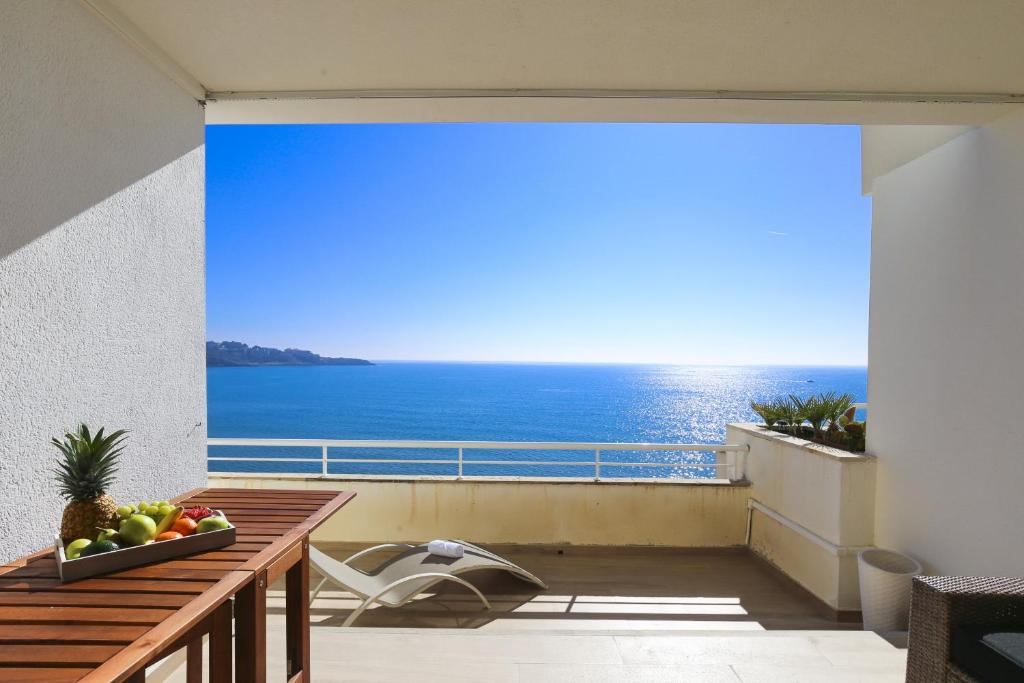 a balcony with a view of the ocean at NEW CALM Planetcostadorada in Salou