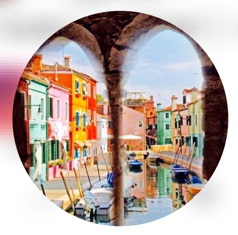 a picture of a canal with buildings and boats at Cà Comare Burano in Burano