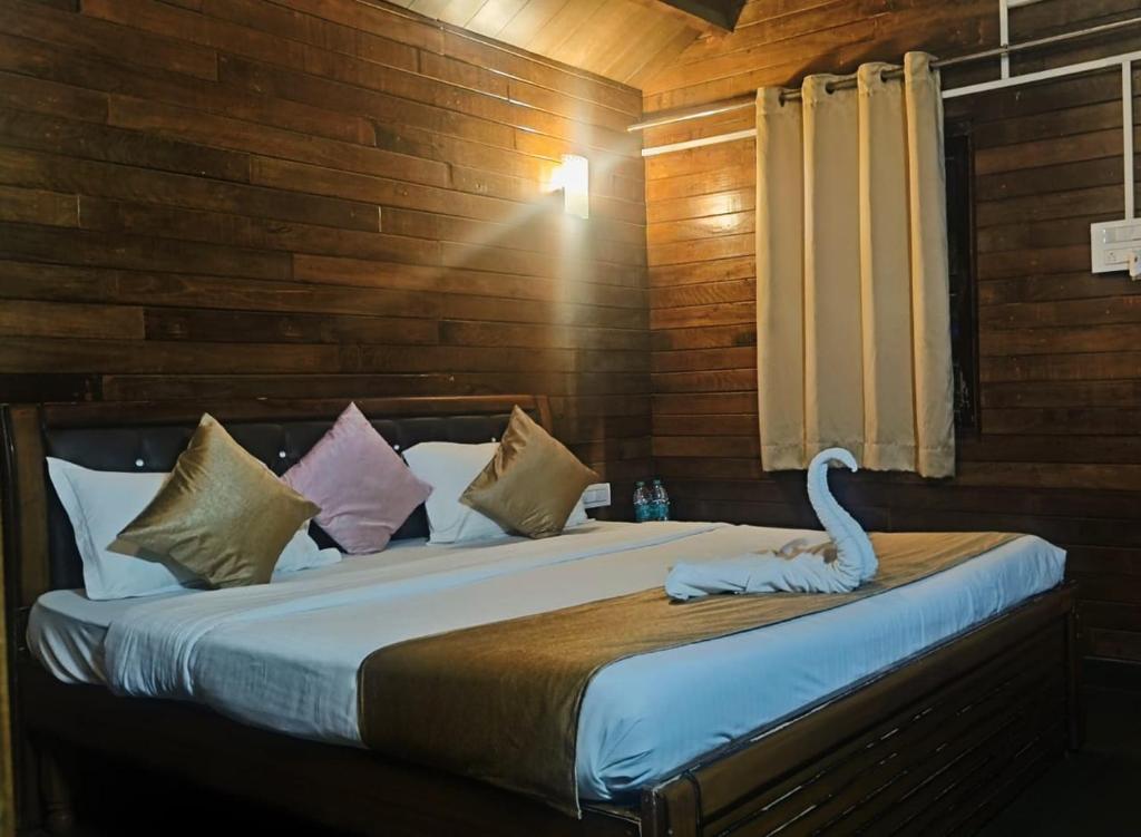 a bedroom with a bed with a white swan on it at Melba Beach Resort By Maitree in Arambol