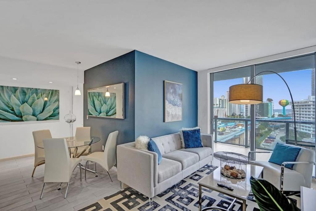 a living room with a couch and a table at Awesome Ocean View Modern Condo Pool Shuttle in Hallandale Beach