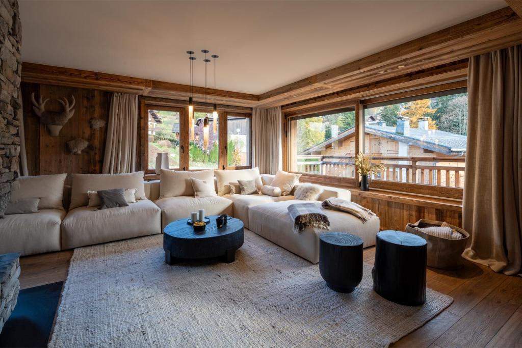 a living room with a couch and a table at Chalet Enigma in La Clusaz