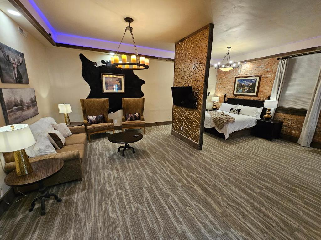a large living room with a couch and a bed at Eaglescape Suites and Event Center in Miles City