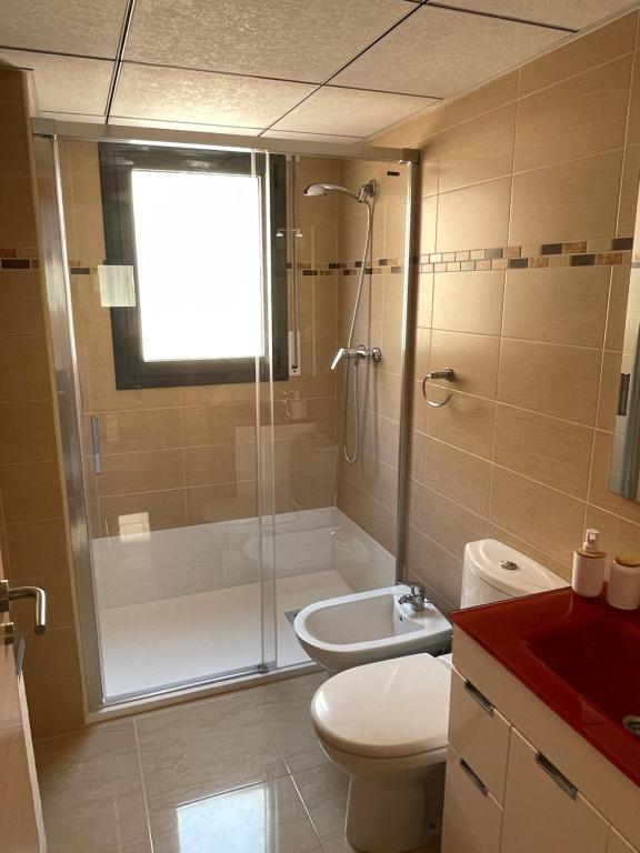 a bathroom with a shower and a toilet and a sink at Evasion in Miami Platja