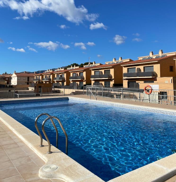 a large swimming pool in front of a building at Evasion in Miami Platja