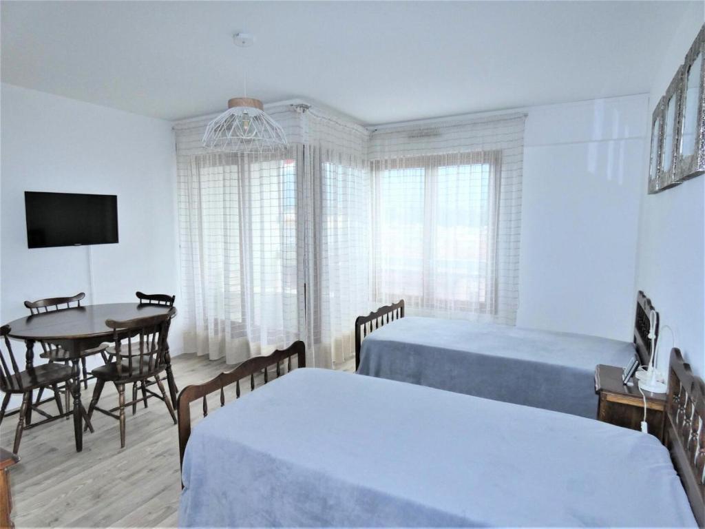 - une chambre avec 2 lits, une table et une salle à manger dans l'établissement Résidence Le Chateau Durieux 3 - Agréable studio, bien situé ! MAE-7574, à Aix-les-Bains