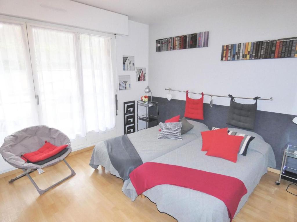 une chambre avec un grand lit et une chaise dans l'établissement Résidence Le Saint Charles A - Studio agréable et moderne à 50m des Thermes Chevalley ! MAE-7444, à Aix-les-Bains