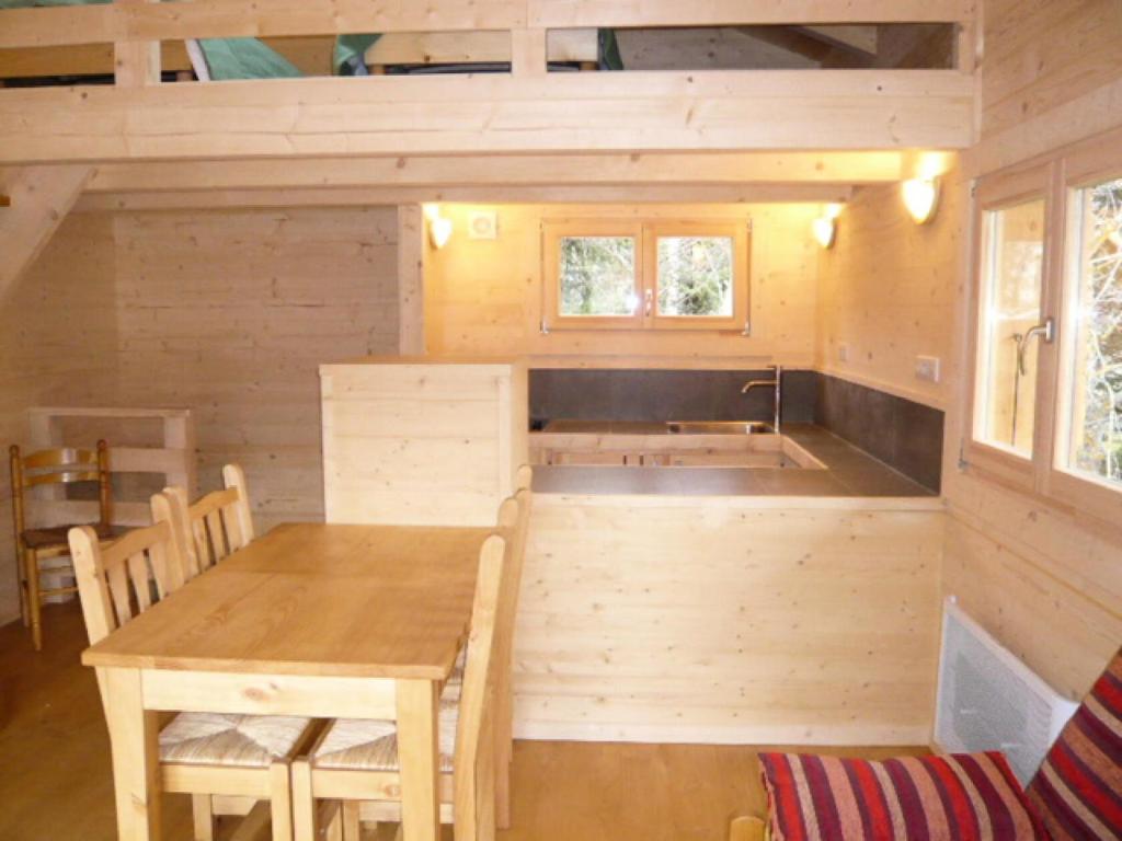 a kitchen and dining room of a tiny house at Chalet - Chalets 494 in Lans-en-Vercors