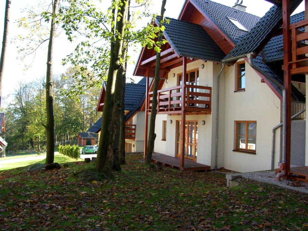 a house with trees in front of it at Domek Karpatka 1 przy wyciągu narciarskim in Karpacz