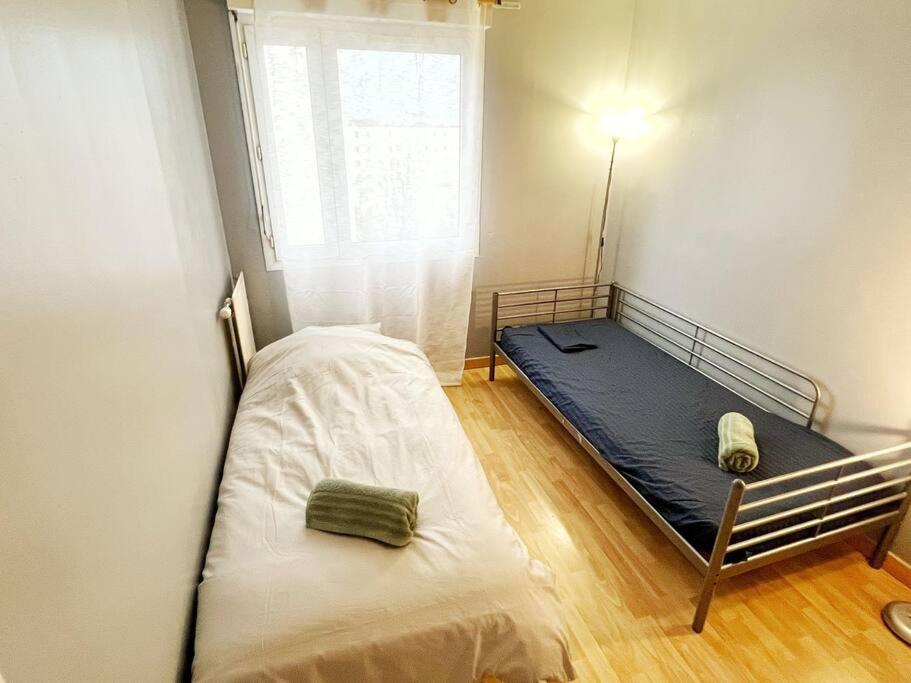 a small bedroom with a bed and a window at Disney et Paris pour 4 personnes RER A in Champs-sur-Marne