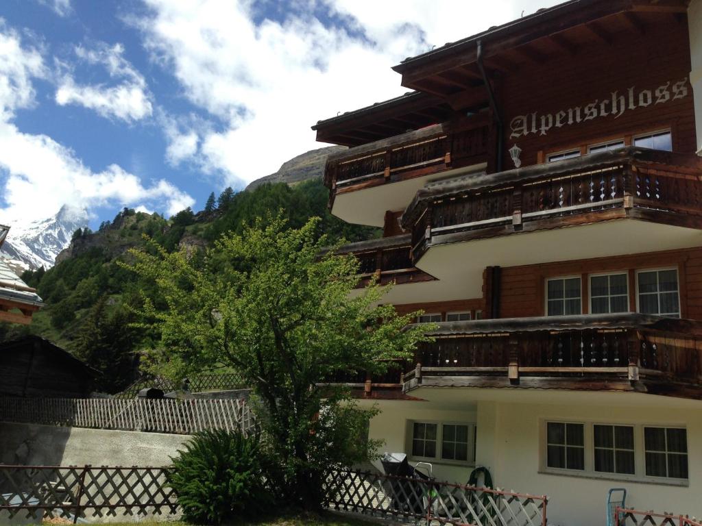 ein Gebäude mit einem Berg im Hintergrund in der Unterkunft Haus Alpenschloss in Zermatt