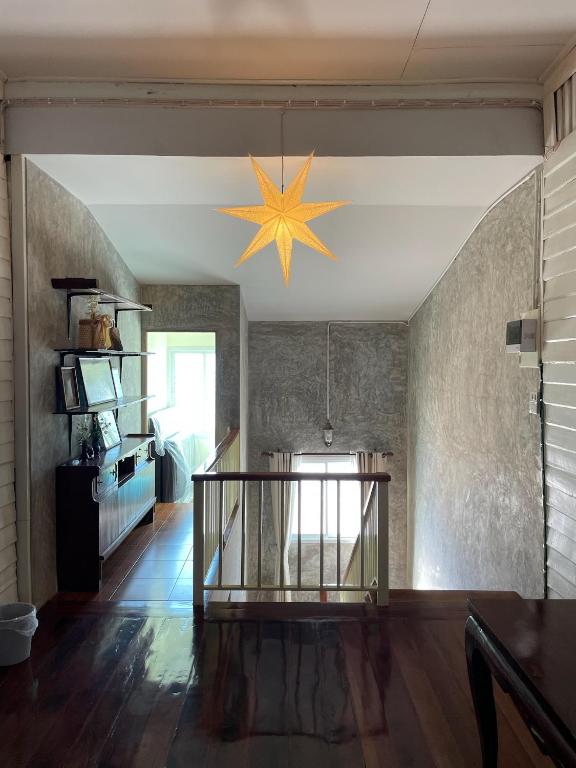 a living room with a star hanging from the ceiling at บ้านแสนรัก Casa Dolce Casa, Prakhon Chai in Prakhon Chai