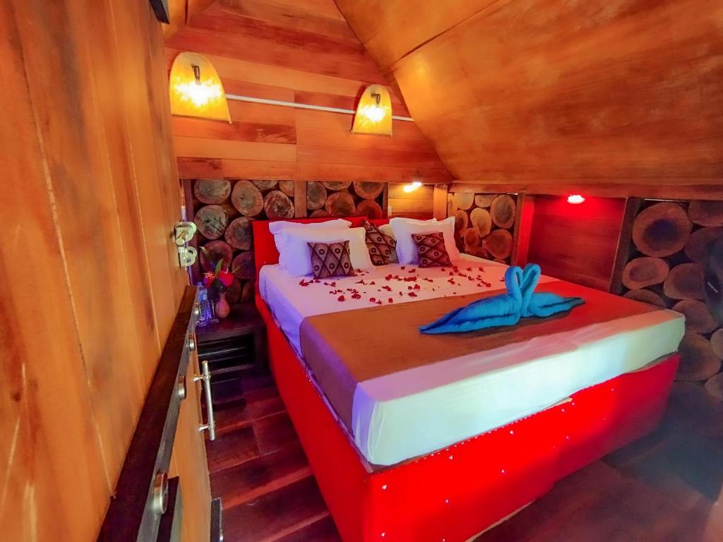 a bedroom with a bed in a cabin at The Banda' Eco Villa in Sigiriya