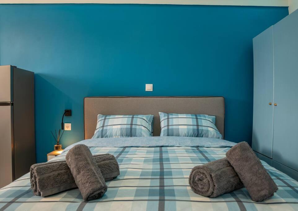 a blue bedroom with a bed with blue walls at Frida's Home for 2 in Kozani in Kozani