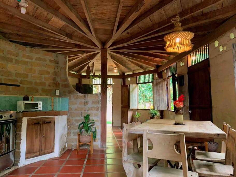 a kitchen with a wooden ceiling and a table at Casa Komerio in Palomino