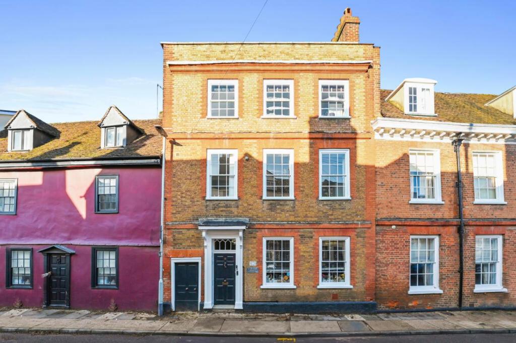 a row of colorful buildings on a street at Stunning Georgian ‘Squires’ Town House - near London in Hertford