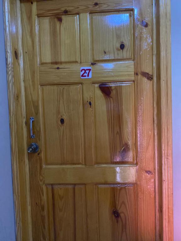 a wooden door with the number on it at Clientèle Hotel in Cap-Haïtien