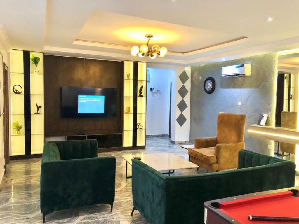 a lobby with couches and a tv and a pool table at Elegant 3 Bedroom Apartment in Lekki