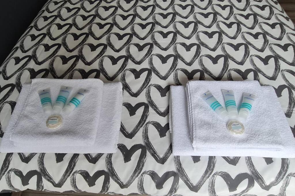 two toothbrushes in towels on top of a bed at Apartment Obi Osijek in Osijek