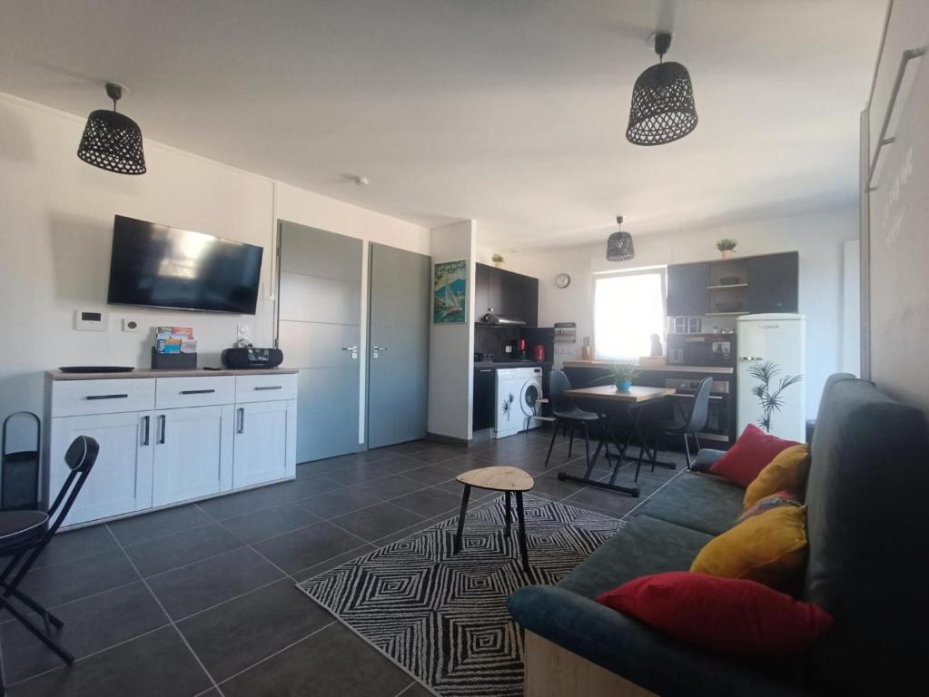 un salon avec un canapé et une cuisine avec une table dans l'établissement Residence Confidence Urbaine - Coup de coeur pour ce joli logement ! MAE-3154, à Aix-les-Bains