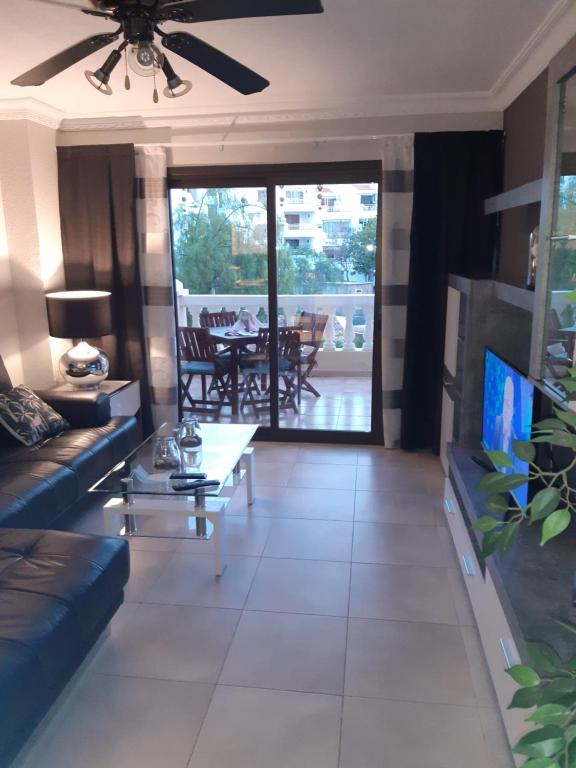 a living room with a couch and a table at NICE 1 BEDROOM APARTMENT LOS CRISTIANOS in Los Cristianos
