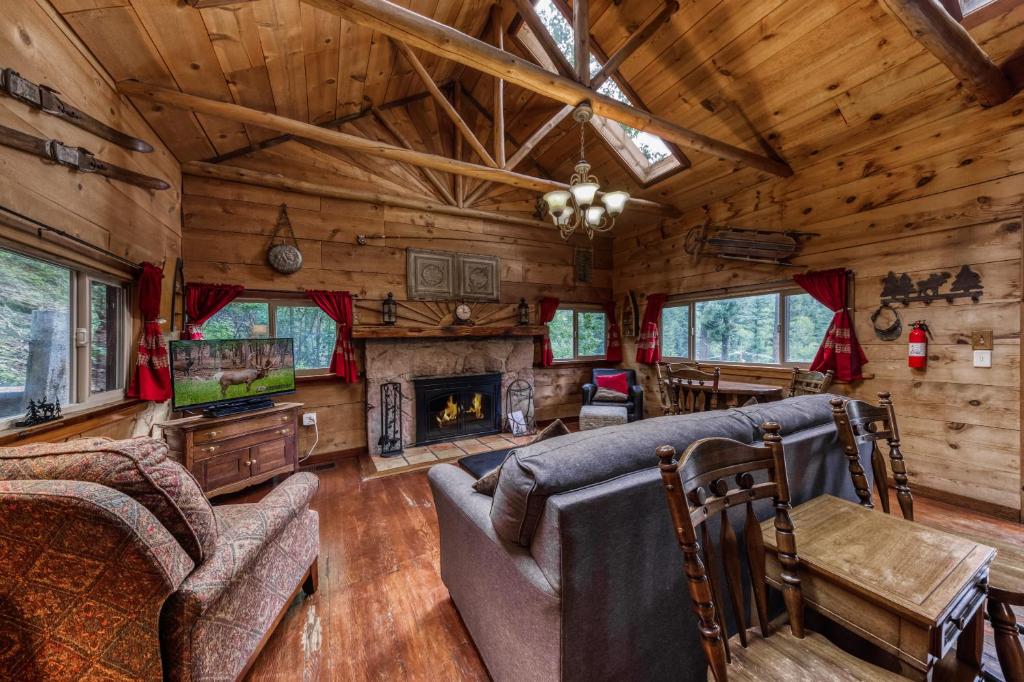 a living room with a couch and a fireplace at Two Bedroom Cabin Used To Belong to Deborah Winger! in Ruidoso