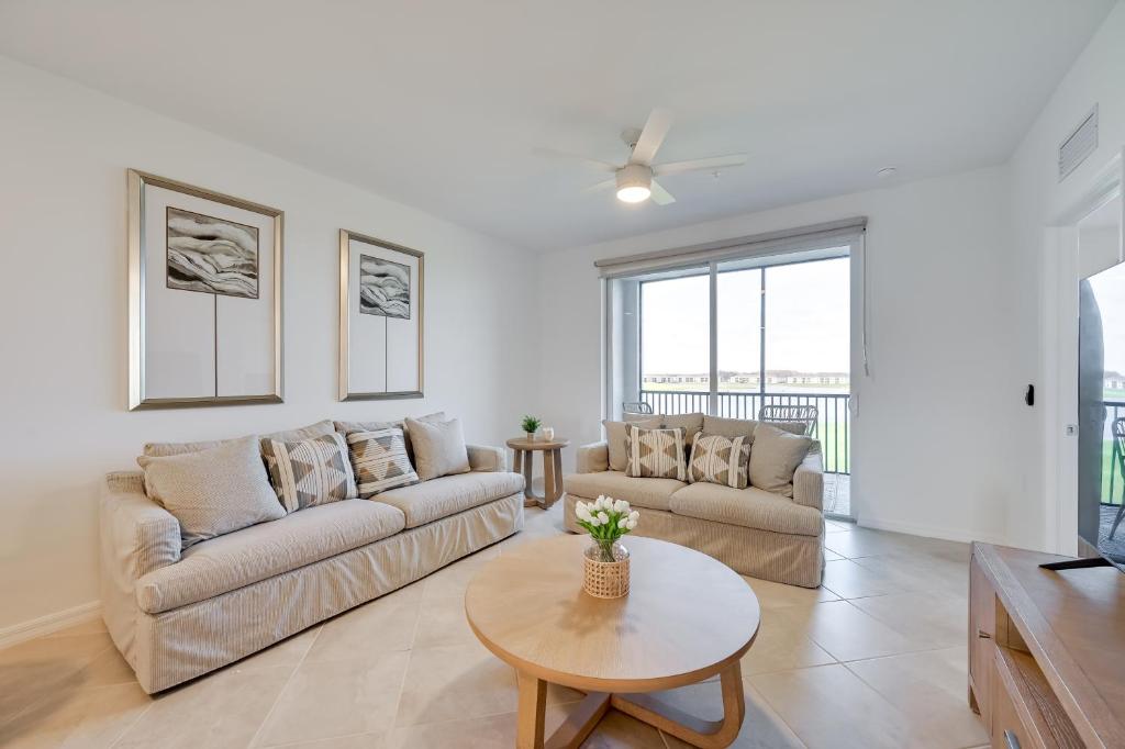 a living room with two couches and a table at Breezy Ave Maria Condo with Golf Course On-Site! in Harker