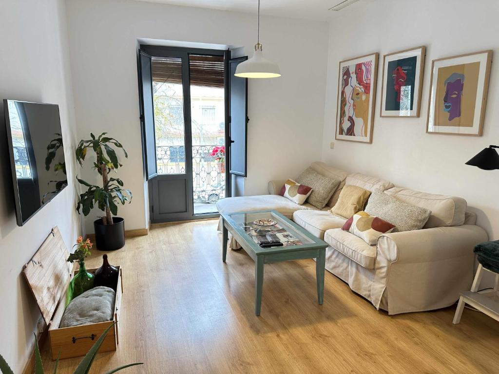 a living room with a couch and a table at Alma de San Bernardo in Seville