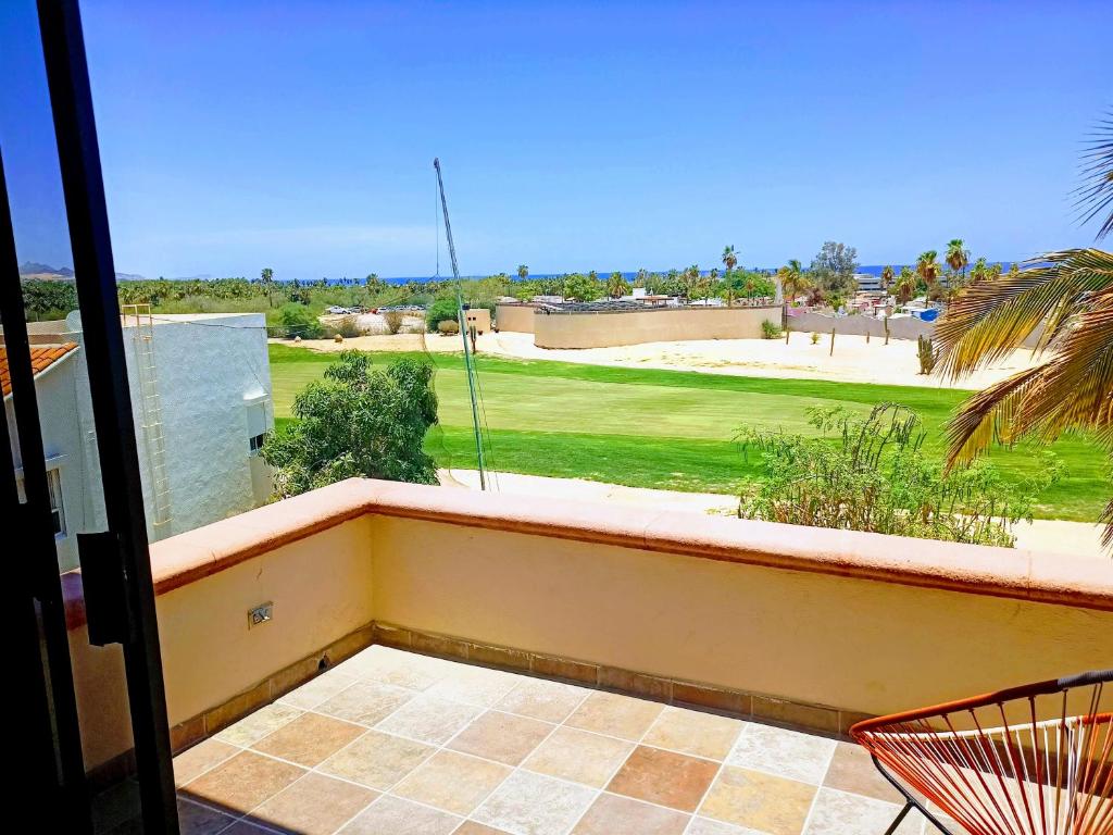 a balcony with a view of a golf course at Hostal San Jose in San José del Cabo