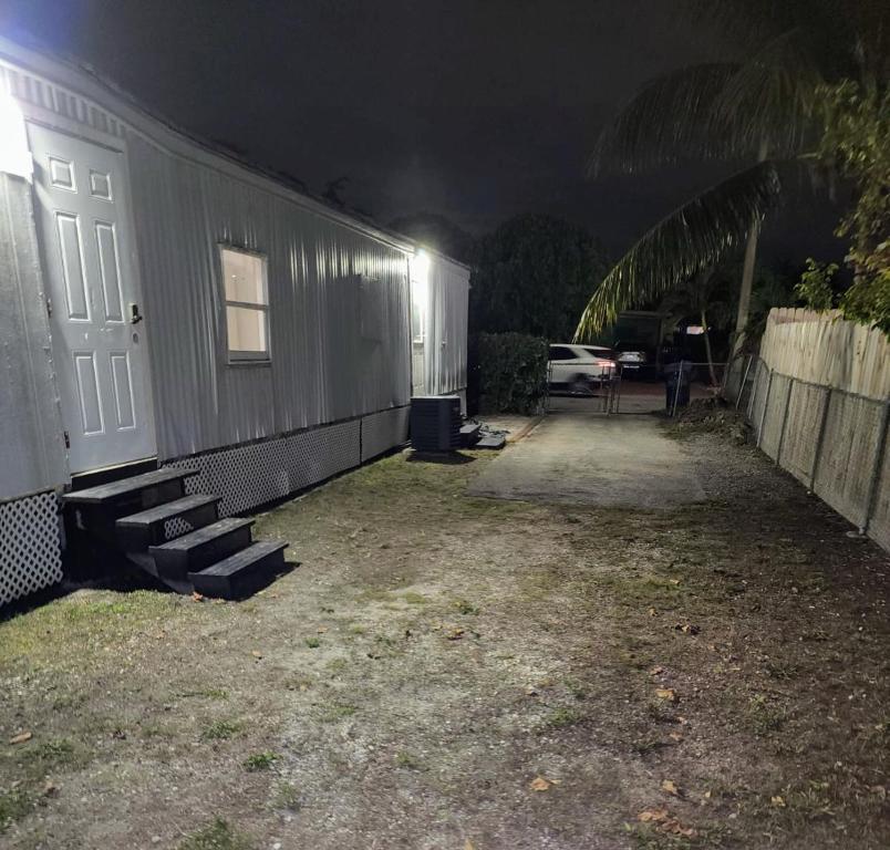 a house with a white door and a yard at night at 13101 Main Home Miami in Miami