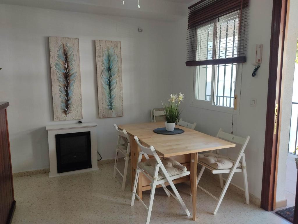 a dining room with a wooden table and chairs at Apartamento Lerele in El Bosque