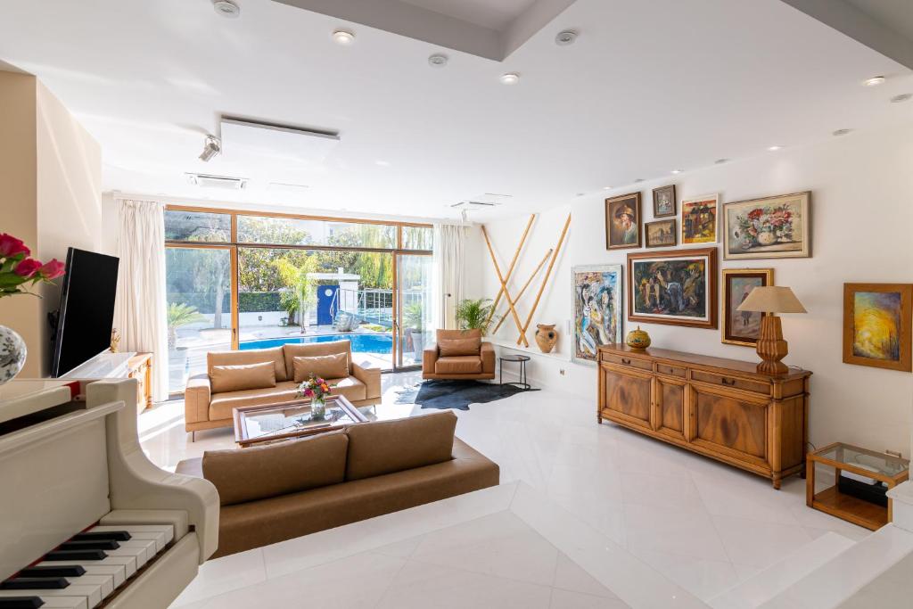 a living room with a piano and a couch at Villa Stefani with Private Pool in Athens