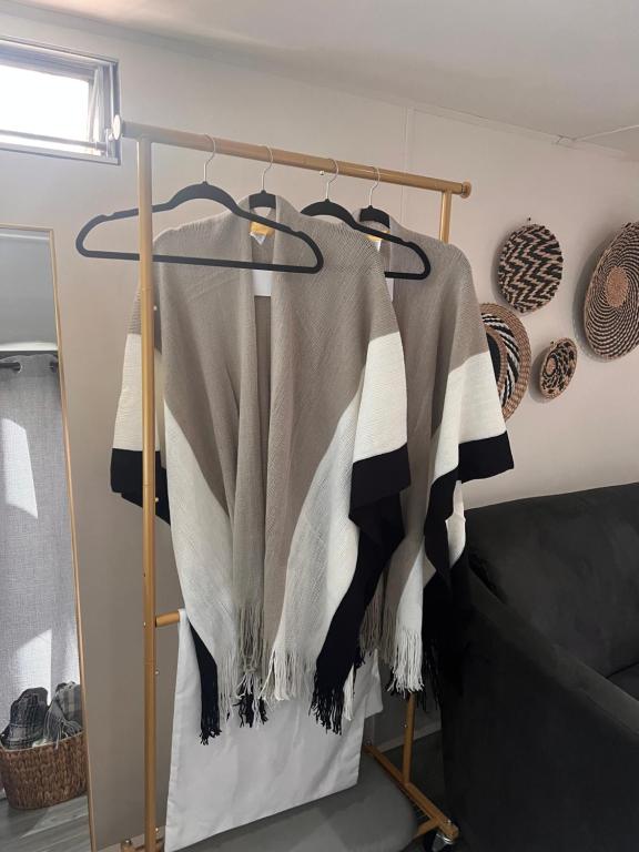 a sweater hanging on a rack in a room at Increíble Moderno Espacio Unico in San Luis Río Colorado