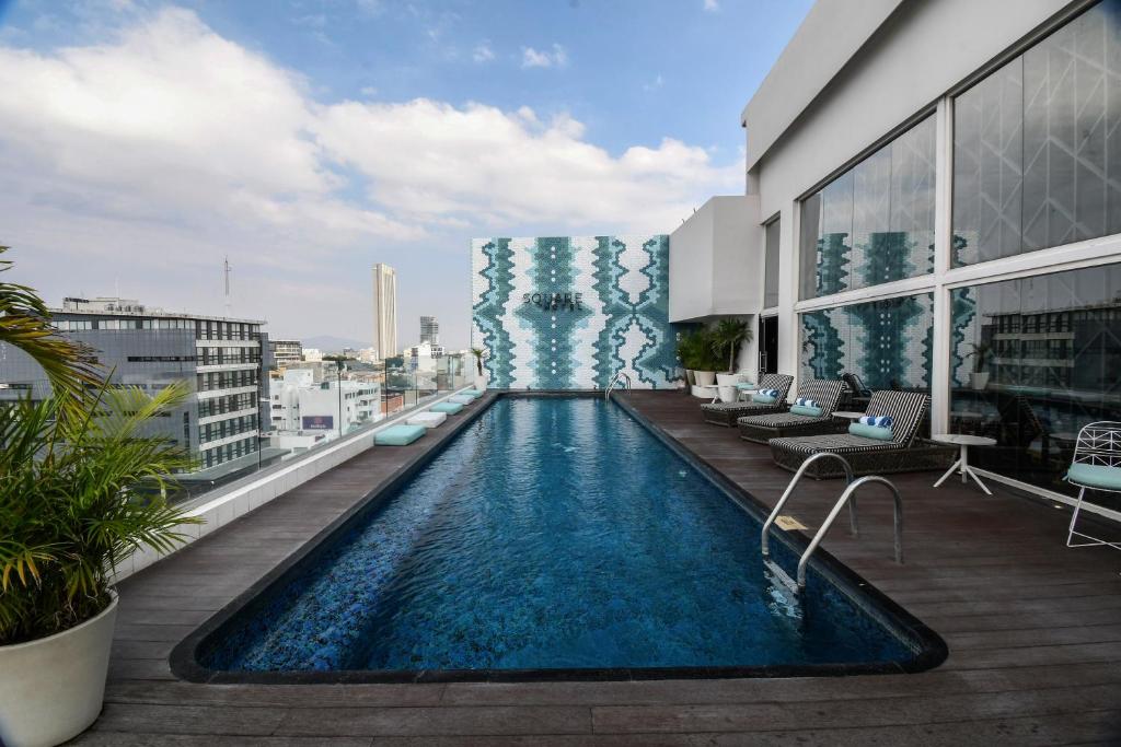a swimming pool on the roof of a building at Square Small Luxury Hotel - Providencia in Guadalajara