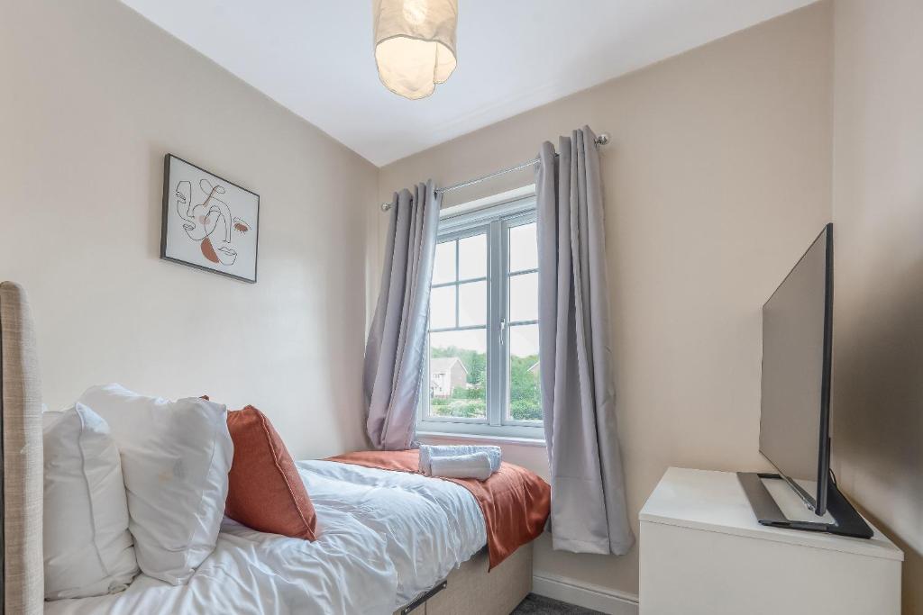 a bedroom with a bed and a window at The Peytons Place in Chorley