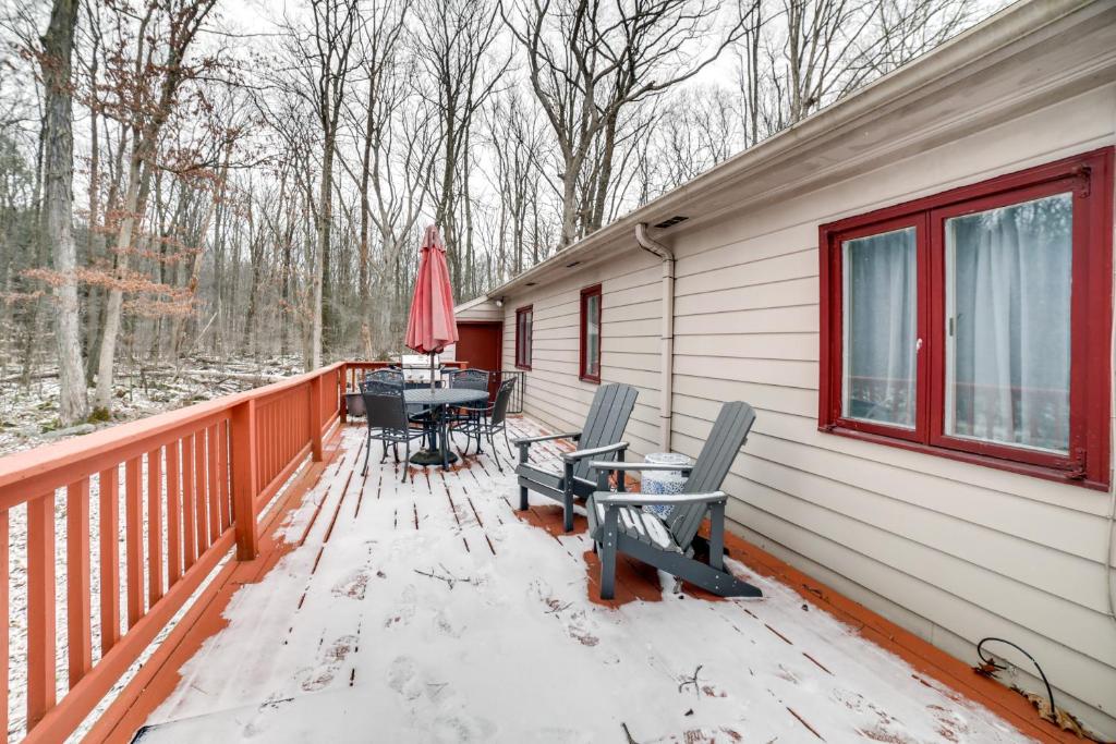 a deck with a table and chairs on it at Rector Home with Hot Tub about 6 Mi to Ligonier! in Rector