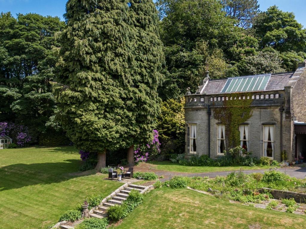 an old house with a garden in front of it at 1 Bed in Glossop 52417 in Glossop