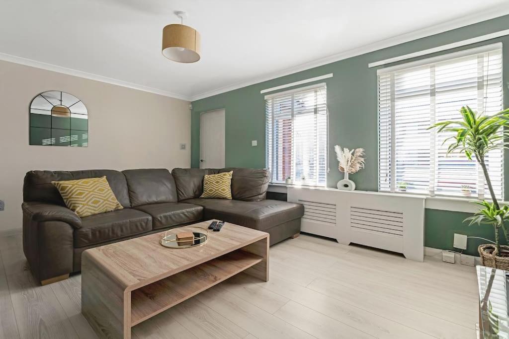 a living room with a couch and a coffee table at Stylish 2-Bed House Private Driveway in Glasgow