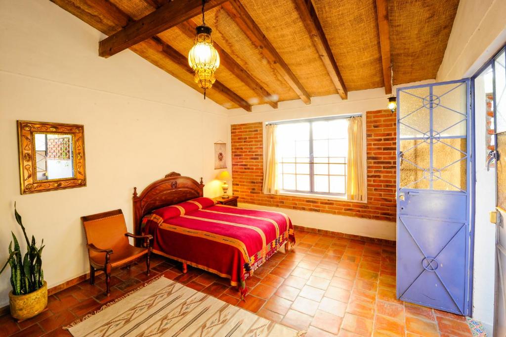 a bedroom with a bed and a window at Casa Aurora in Ajijic