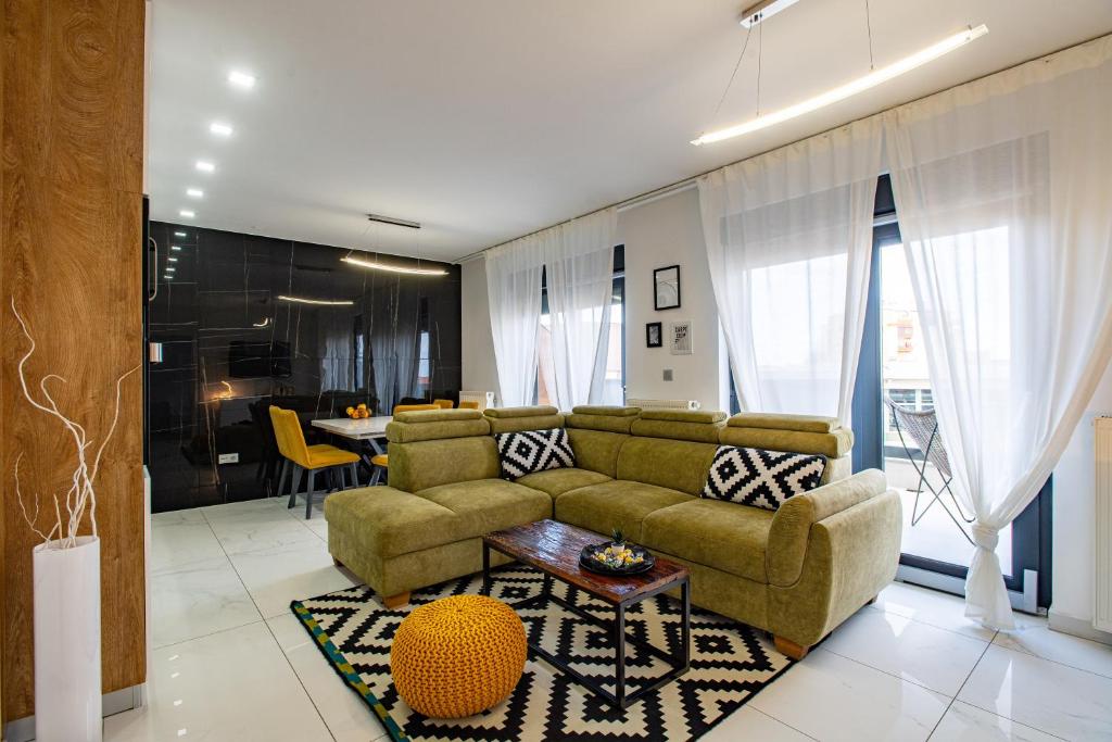 a living room with a couch and a table at Penthouse Apartman Roko in Virovitica