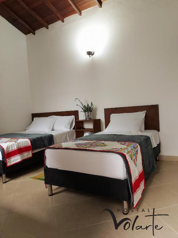 Postel nebo postele na pokoji v ubytování Volarte Hostal