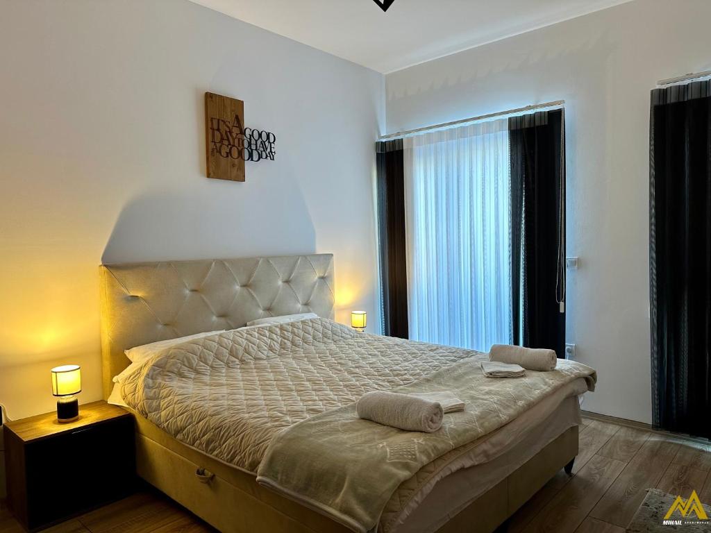 a bedroom with a bed with two towels on it at Mihail Apartments Mavrovo in Mavrovo
