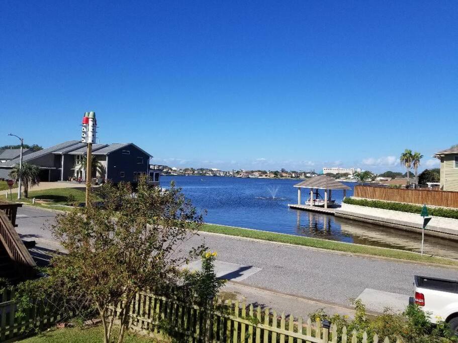 a body of water with a house and a dock at The Seahorse Apt - Lakeside and Close to the Beach in Galveston