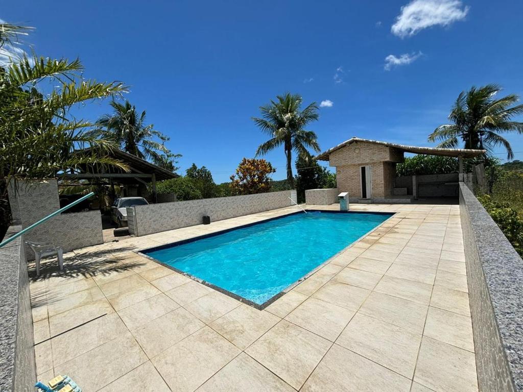 a swimming pool in front of a villa at loft 2 sitio do barrigudinho in Saquarema